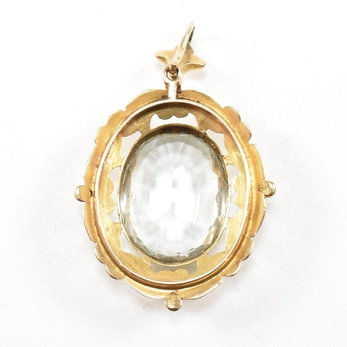 17 - A gold and aquamarine necklace pendant. The pendant set with an oval cut aquamarine within a rococo ... 