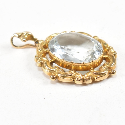 17 - A gold and aquamarine necklace pendant. The pendant set with an oval cut aquamarine within a rococo ... 