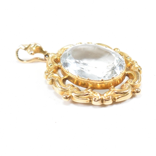 17 - A gold and aquamarine necklace pendant. The pendant set with an oval cut aquamarine within a rococo ... 