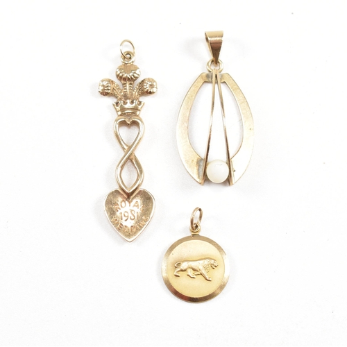 174 - Three hallmarked 9ct gold pendants. The pendant to include a royal wedding commemorative spoon, a mo... 