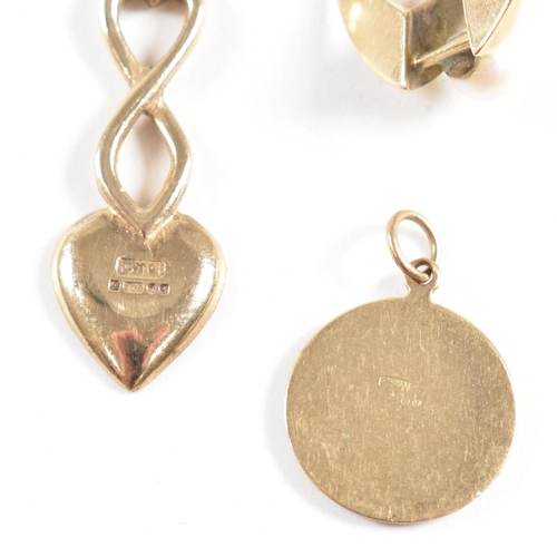 174 - Three hallmarked 9ct gold pendants. The pendant to include a royal wedding commemorative spoon, a mo... 