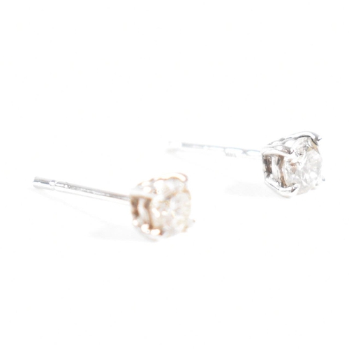 179 - A pair of 14ct white gold and diamond stud earrings. Weight approx 0.3g. Measures approx 0.5mm. All ... 