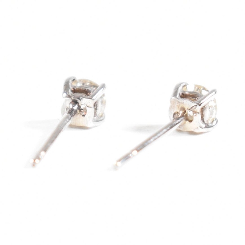 179 - A pair of 14ct white gold and diamond stud earrings. Weight approx 0.3g. Measures approx 0.5mm. All ... 