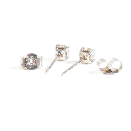 179 - A pair of 14ct white gold and diamond stud earrings. Weight approx 0.3g. Measures approx 0.5mm. All ... 