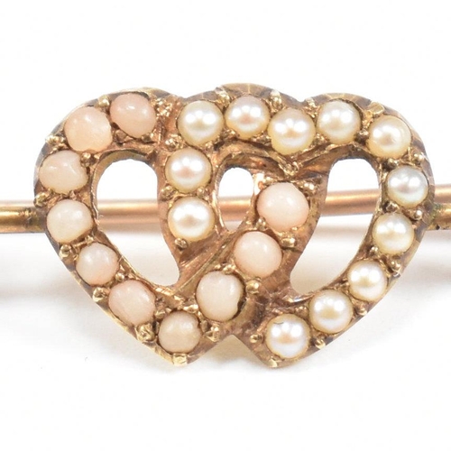 195 - A gold coral and pearl sweetheart brooch pin. The brooch having an entwined heart motif  set with co... 