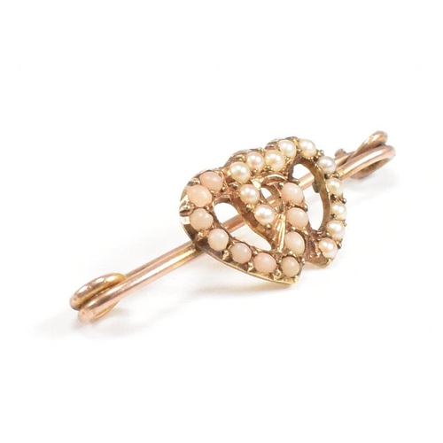 195 - A gold coral and pearl sweetheart brooch pin. The brooch having an entwined heart motif  set with co... 