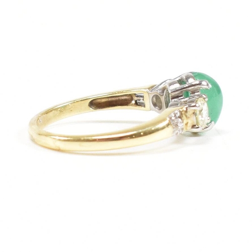 2 - A hallmarked 18ct gold emerald and diamond three stone ring. The ring set with a central emerald ova... 