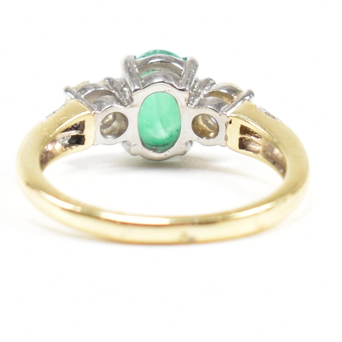 2 - A hallmarked 18ct gold emerald and diamond three stone ring. The ring set with a central emerald ova... 