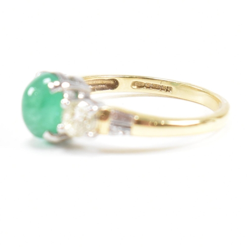 2 - A hallmarked 18ct gold emerald and diamond three stone ring. The ring set with a central emerald ova... 