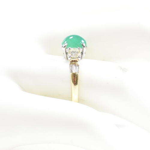 2 - A hallmarked 18ct gold emerald and diamond three stone ring. The ring set with a central emerald ova... 