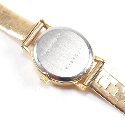 202 - A Longines wrist watch on a hallmarked 9ct gold strap. The Longines watch having a champagne dial wi... 