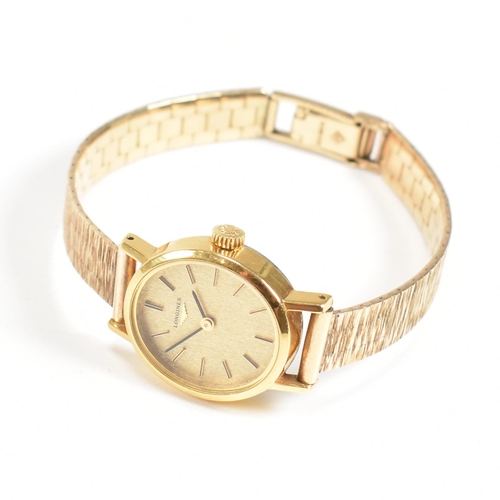 202 - A Longines wrist watch on a hallmarked 9ct gold strap. The Longines watch having a champagne dial wi... 