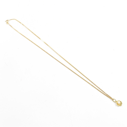 209 - A hallmarked 9ct gold and pearl pendant necklace. The necklace strung with a flower pendant set with... 