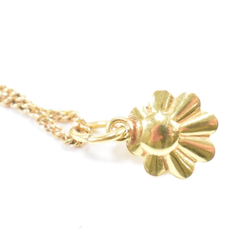 209 - A hallmarked 9ct gold and pearl pendant necklace. The necklace strung with a flower pendant set with... 