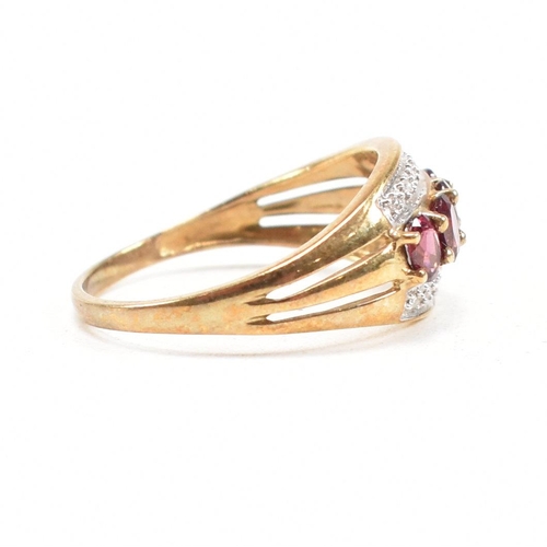 212 - A 9ct gold garnet and diamond dress ring having pierced shoulders and tapering shank. Weight 2.6g. S... 