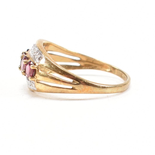 212 - A 9ct gold garnet and diamond dress ring having pierced shoulders and tapering shank. Weight 2.6g. S... 