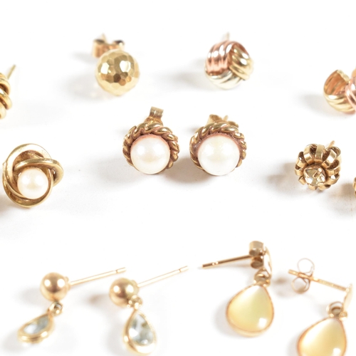 213 - An assortment of gold gem set and yellow metal earrings. The earring to include knot, pearl, topaz. ... 