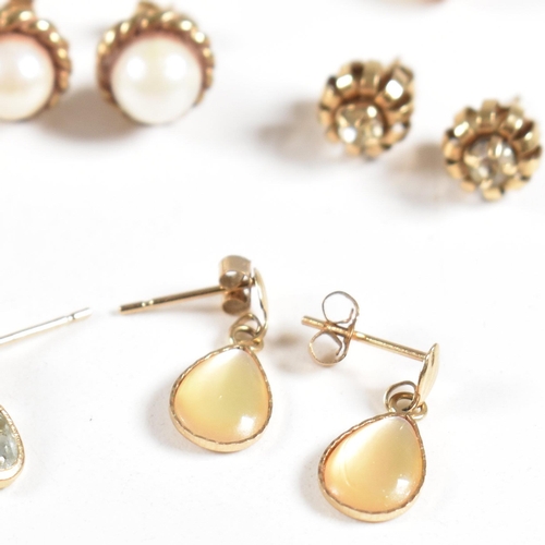 213 - An assortment of gold gem set and yellow metal earrings. The earring to include knot, pearl, topaz. ... 