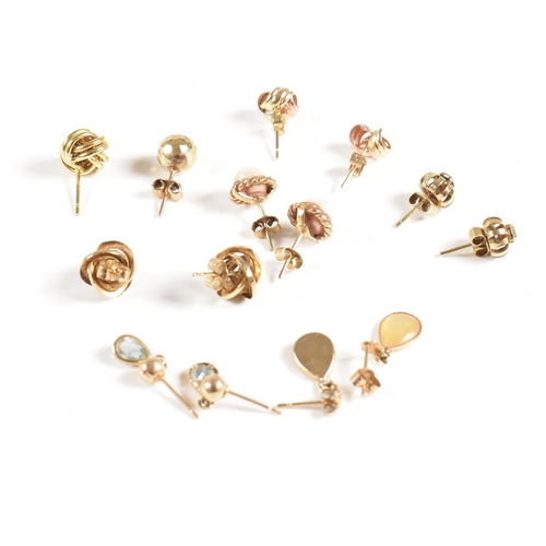 213 - An assortment of gold gem set and yellow metal earrings. The earring to include knot, pearl, topaz. ... 