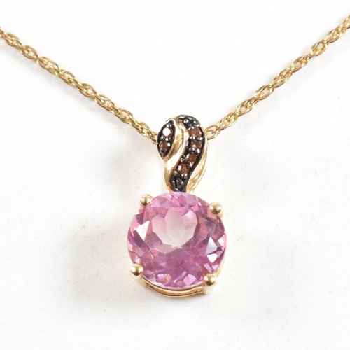 214 - A hallmarked 9ct gold and gem set pendant necklace. the necklace strung with a topaz pendant on a ro... 