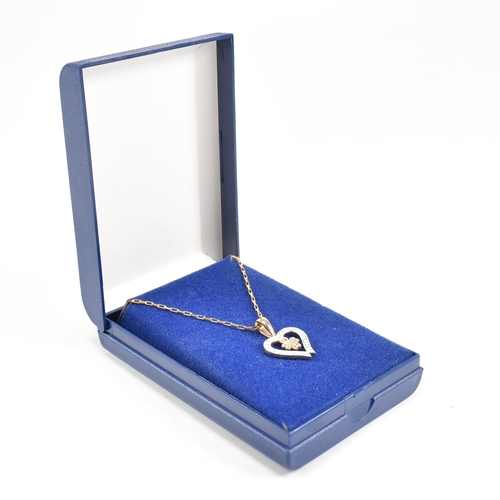 223 - A hallmarked 9ct gold pendant necklace. The necklace strung with a heart pendant on a fine link chai... 