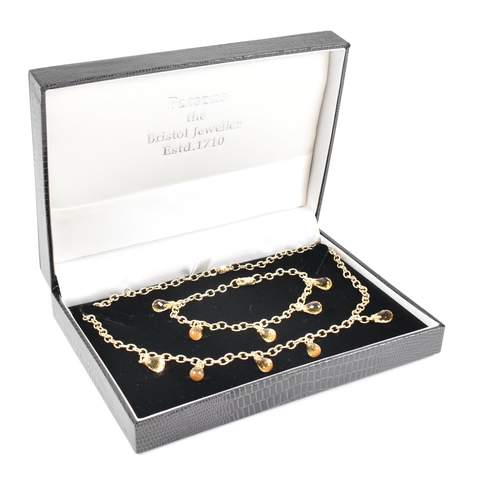 23 - A hallmarked 9ct gold and citrine necklace and bracelet suite. The necklace and bracelet strung with... 