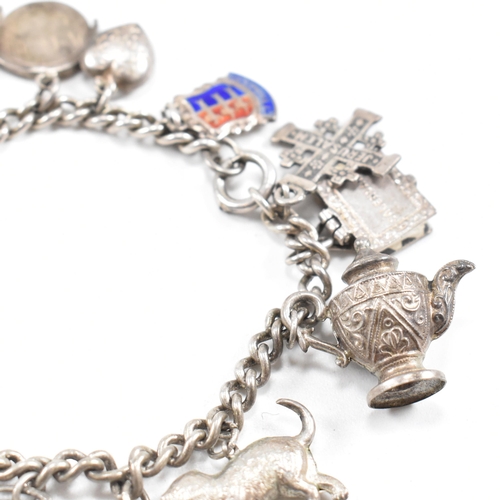 230 - Two silver and white metal charm bracelets adorned with multiple charms to include moon, Welsh drago... 