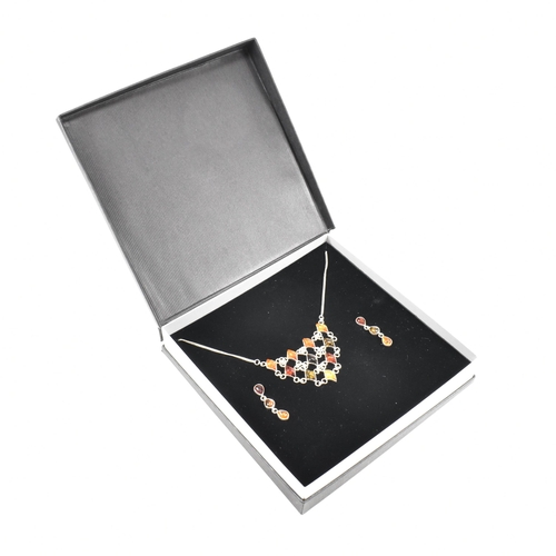 232 - A 925 silver and amber pendant necklace and earring suite. The necklace strung with a harlequin pend... 