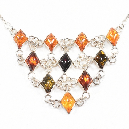 232 - A 925 silver and amber pendant necklace and earring suite. The necklace strung with a harlequin pend... 