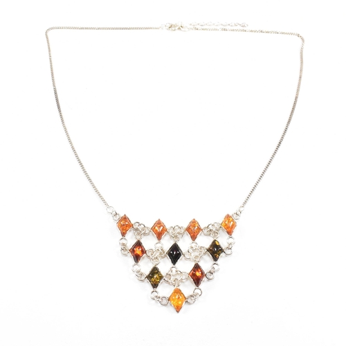 232 - A 925 silver and amber pendant necklace and earring suite. The necklace strung with a harlequin pend... 