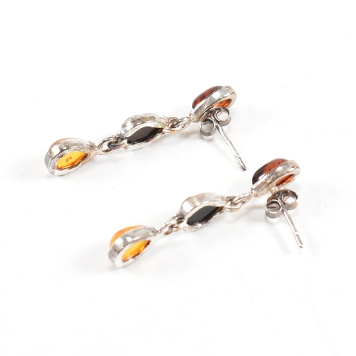 232 - A 925 silver and amber pendant necklace and earring suite. The necklace strung with a harlequin pend... 