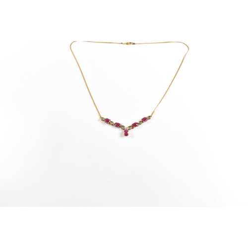 239 - A hallmarked 9ct gold ruby and diamond pendant necklace. Total weight 4.6g. Measures 45cm. All weigh... 