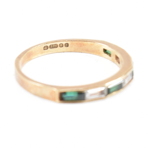 244 - A hallmarked 9ct gold synthetic spinel half hoop ring. The ring set with white and green baguette cu... 