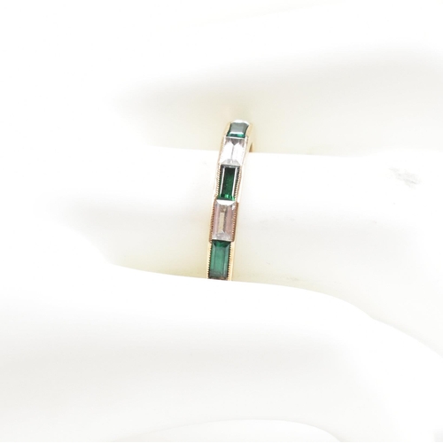 244 - A hallmarked 9ct gold synthetic spinel half hoop ring. The ring set with white and green baguette cu... 