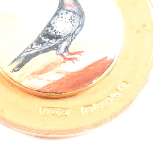 25 - A hallmarked 15ct gold enamel pigeon medal pendant. Hallmarked Birmingham. WHH for William Hair Hase... 