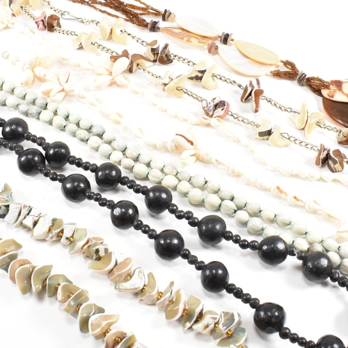 253 - A collection of mid century bead necklaces. The necklaces to include shell, mother of pearl, seed, a... 