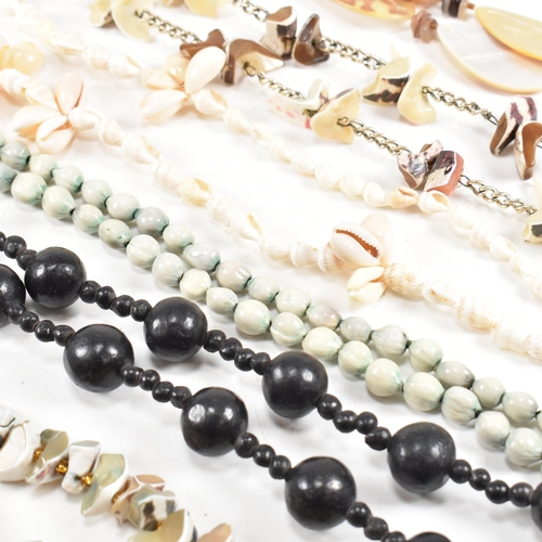 253 - A collection of mid century bead necklaces. The necklaces to include shell, mother of pearl, seed, a... 