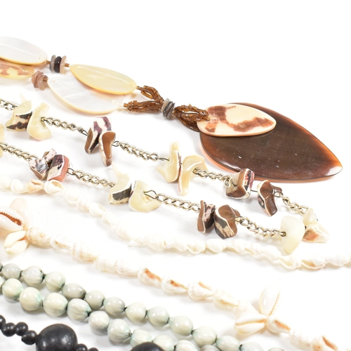 253 - A collection of mid century bead necklaces. The necklaces to include shell, mother of pearl, seed, a... 