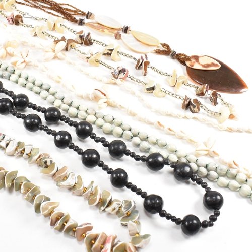 253 - A collection of mid century bead necklaces. The necklaces to include shell, mother of pearl, seed, a... 