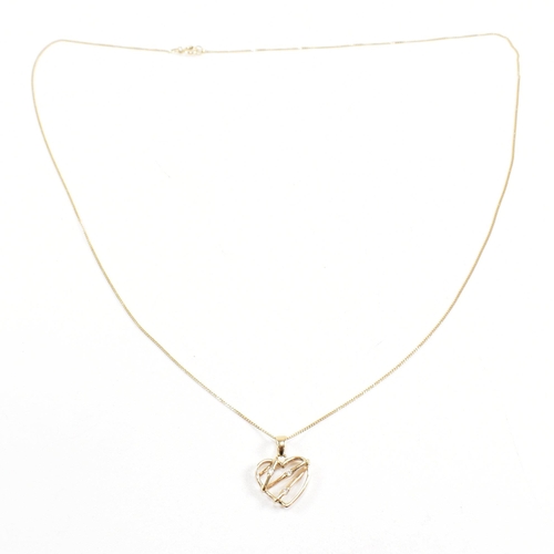 256 - A 9ct gold chain necklace strung with a hallmarked gem set heart pendant. Weight 1.8g. Measures chai... 