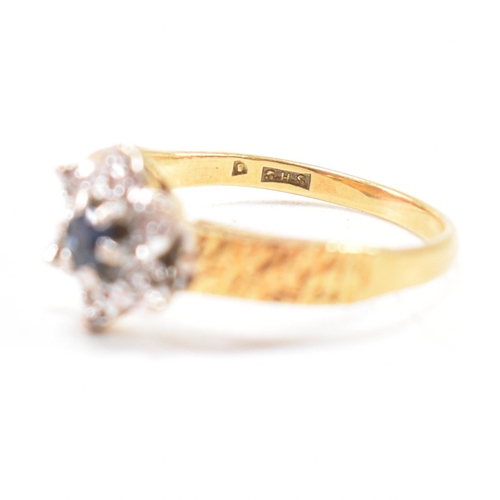 26 - A hallmarked 18ct gold sapphire cluster ring. The ring hallmarked London. Weight 3.5g. Size N. All w... 