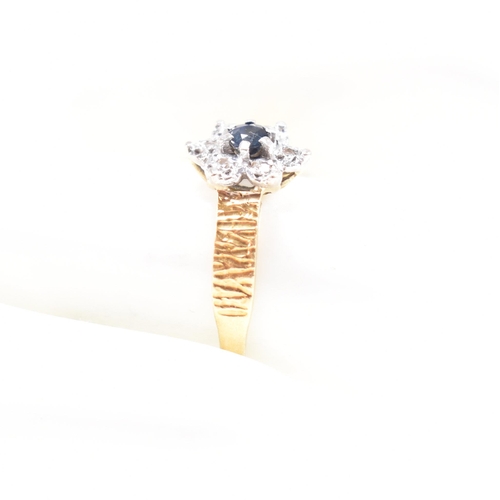 26 - A hallmarked 18ct gold sapphire cluster ring. The ring hallmarked London. Weight 3.5g. Size N. All w... 