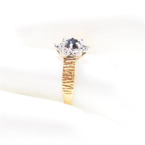 26 - A hallmarked 18ct gold sapphire cluster ring. The ring hallmarked London. Weight 3.5g. Size N. All w... 