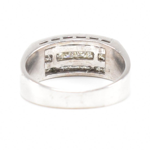 270 - An 18ct white gold and diamond ring. The ring set with three graduated rows of princess cut diamonds... 