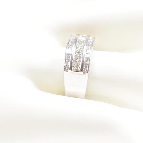 270 - An 18ct white gold and diamond ring. The ring set with three graduated rows of princess cut diamonds... 