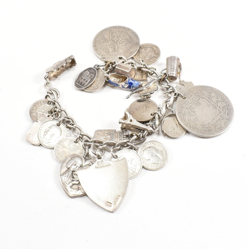 273 - A  silver and white metal charm bracelet AF. The bracelet strung with multiple charms including Vict... 