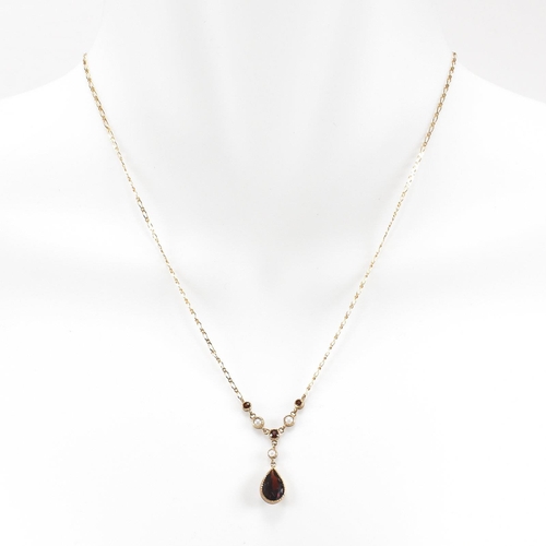 285 - A hallmarked 9ct gold garnet and pearl pendant necklace.  Weight 2.7g. Measures 40cm plus pendant 2.... 