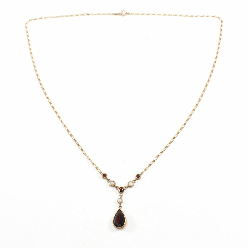 285 - A hallmarked 9ct gold garnet and pearl pendant necklace.  Weight 2.7g. Measures 40cm plus pendant 2.... 