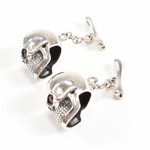 289 - A contemporary pair of 925 silver skull novelty cufflinks. Stamped 925. Weight approx 12.9g. Measure... 