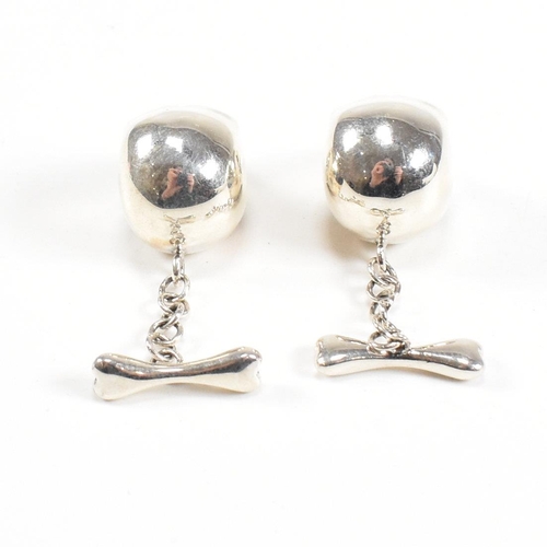 289 - A contemporary pair of 925 silver skull novelty cufflinks. Stamped 925. Weight approx 12.9g. Measure... 